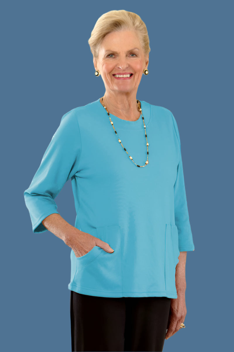 Solid Moon Pocket Wrap Back Top for women by Buck & Buck in Turquoise, and available in different sizes. This tops item is part of our blouses collection.