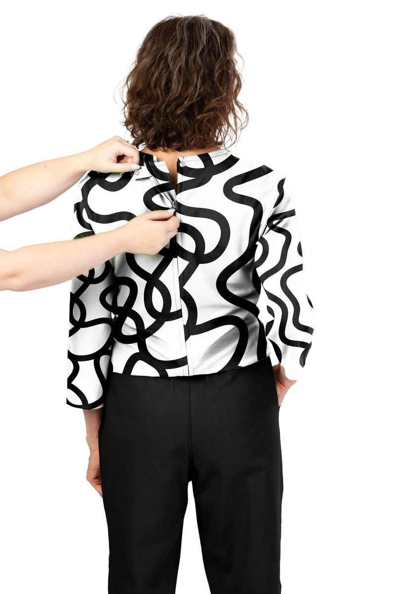 Women's Tunic Jumpsuit by Buck & Buck in White Top/Black Pants, and available in different sizes. This one-piece garments item is part of our one-pieces collection.