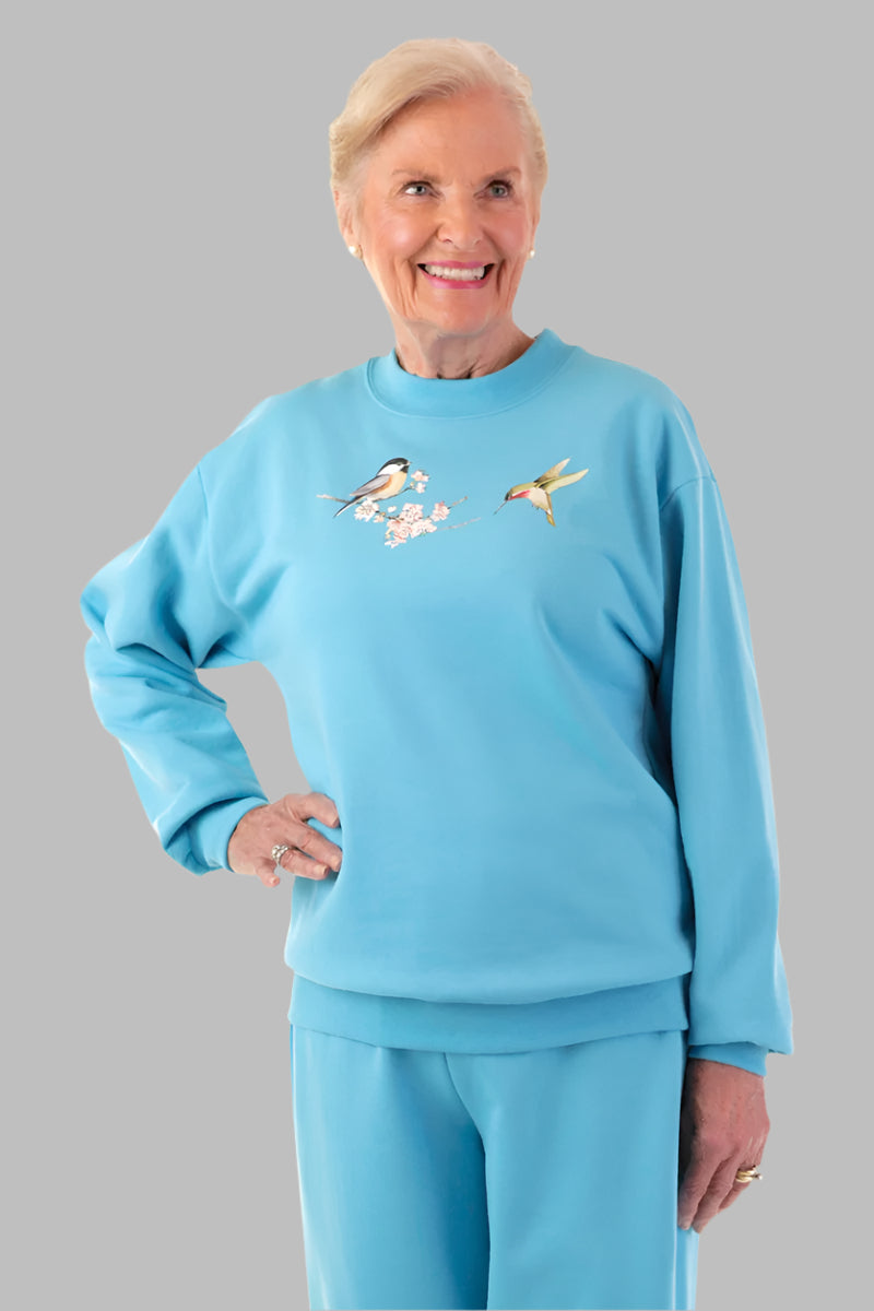 Women's Printed Wrap Back Sweat Top by Buck & Buck in Medium Blue, and available in different sizes. This tops item is part of our sweatshirts collection.